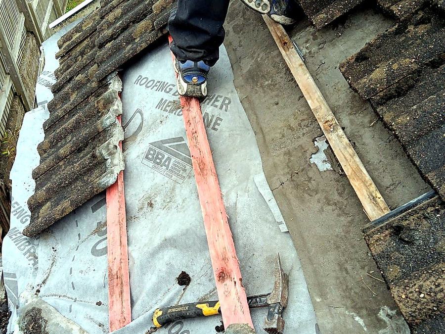 Re-roofing in progress with breather membrane